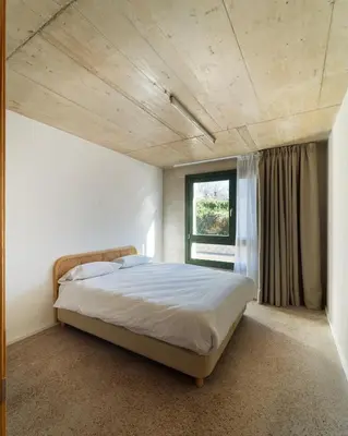a bedroom with a large bed and a window at Mooeve Montjuïc in Barcelona