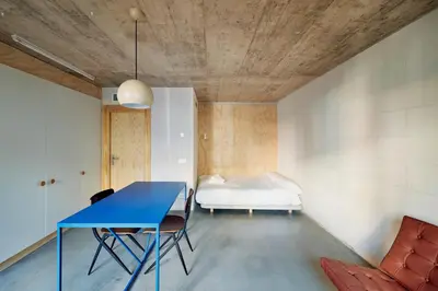 a bedroom with a blue table and a bed at Mooeve Montjuïc in Barcelona