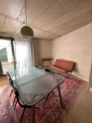 a living room with a glass table and a couch at Mooeve Montjuïc in Barcelona