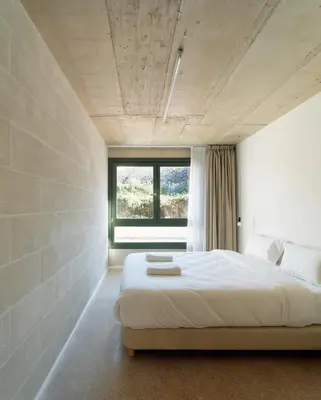 a bedroom with a large bed and a window at Mooeve Montjuïc in Barcelona