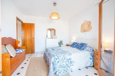 a bedroom with a bed and a mirror at Can Montardo in Sant Pere de Ribes