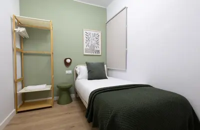 a small bedroom with a bed with a black blanket at Stay U-nique Apartment Passeig d´Amunt in Barcelona