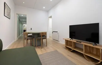 a living room with a flat screen tv and a table at Stay U-nique Apartment Passeig d´Amunt in Barcelona
