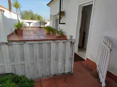 a porch with potted plants and a fence at Suite de invitados independiente in Cerdanyola del Valles