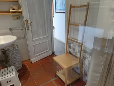 a bathroom with a sink and a glass shower door at Suite de invitados independiente in Cerdanyola del Valles