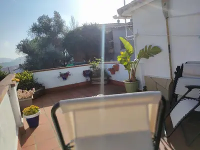 a patio with potted plants on a balcony at Suite de invitados independiente in Cerdanyola del Valles