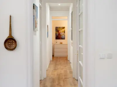 a hallway with white walls and wooden floors at Apartment amazing Sagrada familia view II in Barcelona