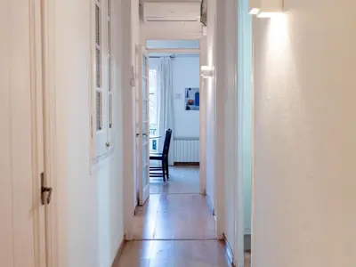 a hallway leading to a room with a table and chairs at Apartment amazing Sagrada familia view I in Barcelona