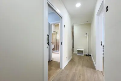 an open hallway with white walls and wood floors at Habitación 6 con baño junto a Las Ramblas in Barcelona