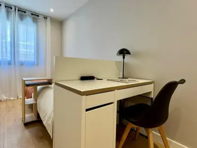 a bedroom with a desk with a chair and a bed at Brand new apartment with views in Barcelona in Barcelona