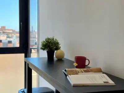 a table with a book and a plant on it at Brand new apartment with views in Barcelona in Barcelona