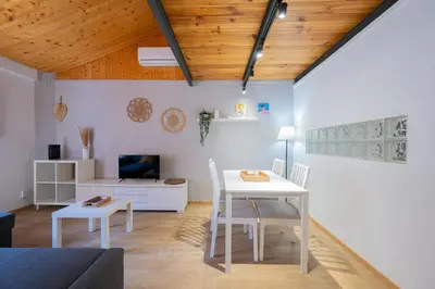 a living room with a white table and chairs at Apartamento Completo junto playa y Centro Bcn in Badalona