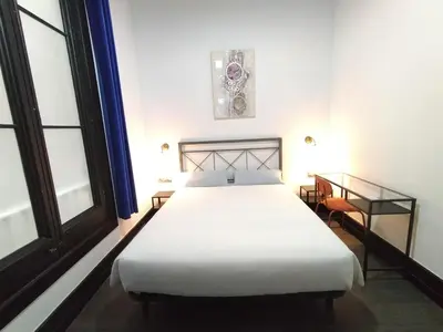 a bedroom with a white bed and a desk at Hotelito Luxe in Barcelona