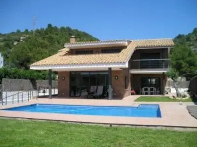 a house with a swimming pool in the yard at Shambala B&B in Sitges