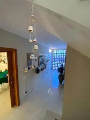 a living room with a staircase and a dining room at Shambala B&B in Sitges