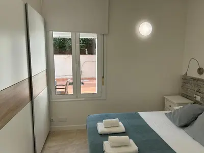 a bedroom with a bed with two towels on it at Apartamentos ELMA1 in Castelldefels