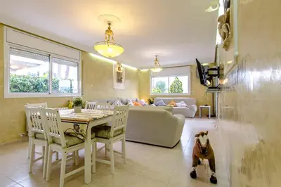 a living room with a table and a dog sitting in the room at Catalunya Casas Costa Dorada Paradise, 2 km from beach! in Cunit