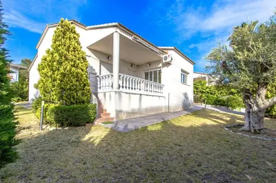 a white house with a tree in the yard at Catalunya Casas Costa Dorada Paradise, 2 km from beach! in Cunit