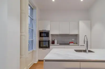 a white kitchen with a sink and a stove at Guest Ready - Modern apartment by Barcelona Port in Barcelona