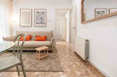 a living room with a couch and a table at Charming 3-Bedroom Flat in the Heart of Les Corts in Barcelona