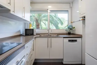a kitchen with a sink and a window at Charming 3-Bedroom Flat in the Heart of Les Corts in Barcelona