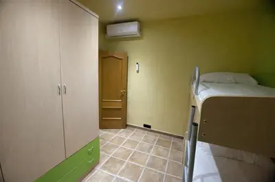 a small room with a bed and a room with a door at Winahost les Faldas del Montseny in Sant Pere de Vilamajor