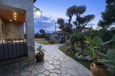 a garden with plants and a stone walkway at Winahost les Faldas del Montseny in Sant Pere de Vilamajor