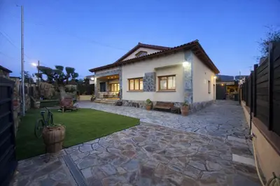 a house with a stone patio in front of it at Winahost les Faldas del Montseny in Sant Pere de Vilamajor