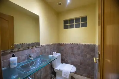 a bathroom with a sink and a toilet and a mirror at Winahost les Faldas del Montseny in Sant Pere de Vilamajor