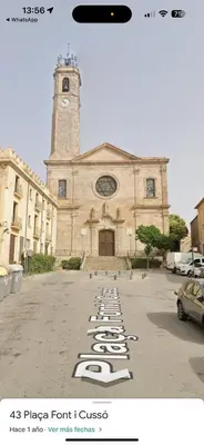 a church with a building with a clock tower at Badalona Old town in Badalona