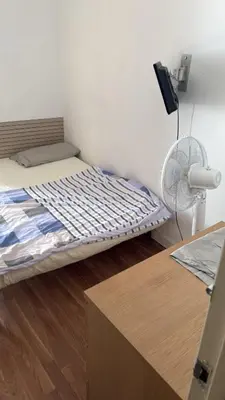 a small bedroom with a bed and a fan at Badalona Old town in Badalona