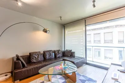 a living room with a couch and a glass table at Apartment Barcelona Rentals - 3 bedroom penthouse with large terrace in Barcelona