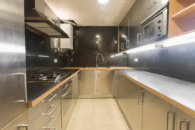 a kitchen with stainless steel cabinets and a stove at Apartment Barcelona Rentals - 3 bedroom penthouse with large terrace in Barcelona