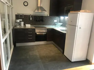 a kitchen with a white refrigerator and a stove at Apartment Poble Nou in Barcelona