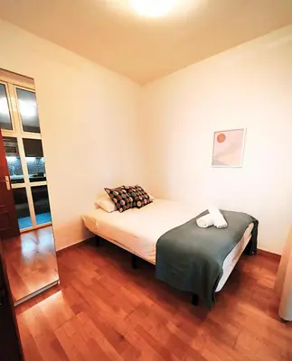 a small bedroom with a bed and a window at Apartment Poble Nou in Barcelona