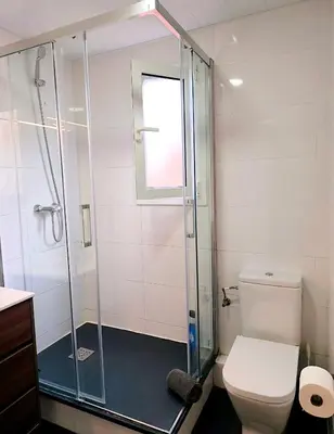 a bathroom with a toilet and a glass shower at Apartment Poble Nou in Barcelona