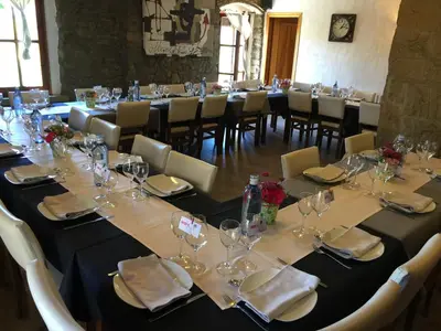 a long table with wine glasses and napkins on it at HOTEL RESTAURANT TURÓ de la TORRE in Manresa