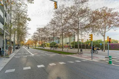 an empty city street with a traffic light and trees at Canela Homes BARCELONA POBLENOU in Barcelona