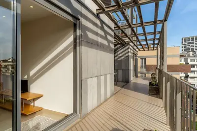 a balcony with a large glass door on a building at Canela Homes BARCELONA POBLENOU in Barcelona