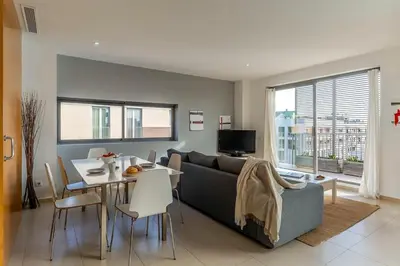 a living room with a couch and a table at Canela Homes BARCELONA POBLENOU in Barcelona