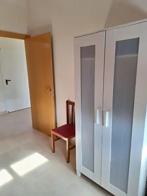 a bedroom with a bed and a red wall at Family-friendly house 20' from Barcelona in Castellví de Rosanés