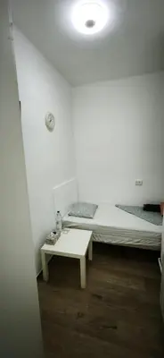 a white room with a bed and a table at Playa de Sant Adrià de Besòs in Sant Adria de Besos