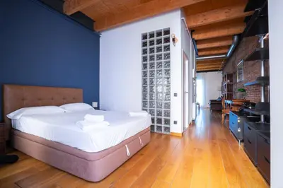a bedroom with a large bed and a blue wall at Barcelona - Loft Paseo de gracia in Barcelona