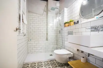a white bathroom with a toilet and a sink at Barcelona - Loft Paseo de gracia in Barcelona