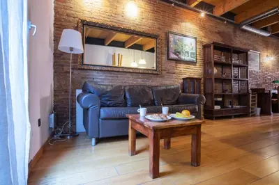 a living room with a couch and a table at Barcelona - Loft Paseo de gracia in Barcelona