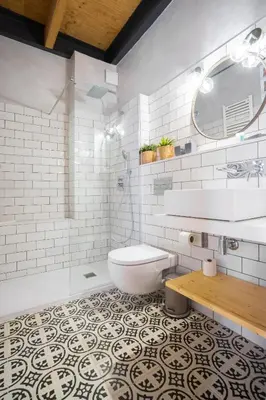 a bathroom with a toilet and a sink and a mirror at Barcelona - Loft Paseo de gracia in Barcelona