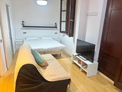 a small room with two beds and a flat screen tv at Barceloneta Beach 2 in Barcelona