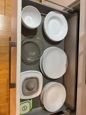 a drawer filled with white plates and bowls at Barceloneta Beach 2 in Barcelona