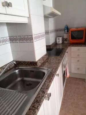 a kitchen with a sink and a microwave at Estrella Primero De Mayo in Sitges