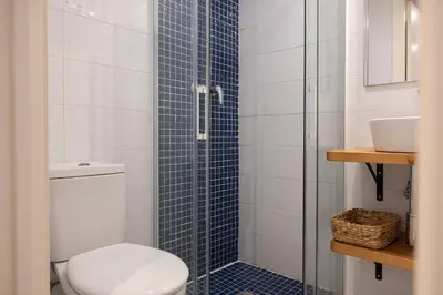 a bathroom with a toilet and a glass shower at Stay U-nique Sant Pau in Barcelona